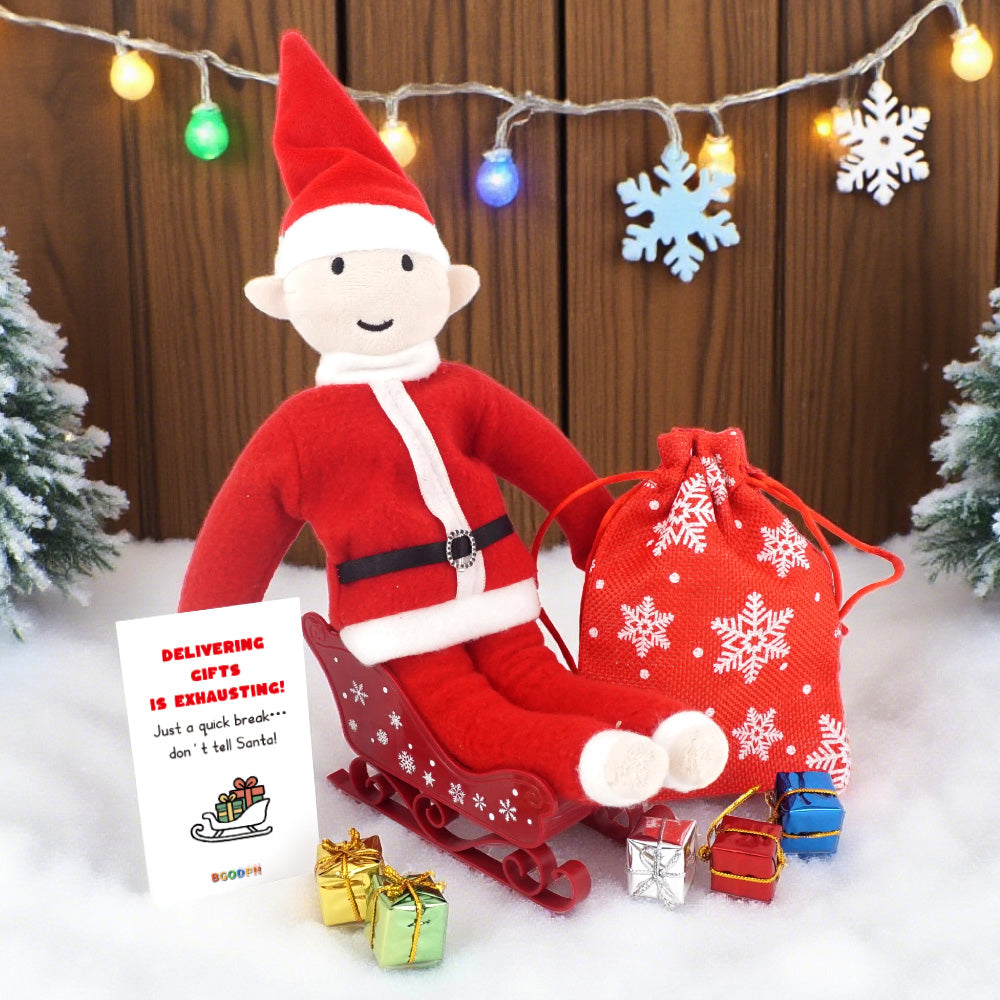 Christmas elf prop set with red sleigh, gift bag, mini gift boxes, snowflake stickers, and activity card for holiday elf scene display