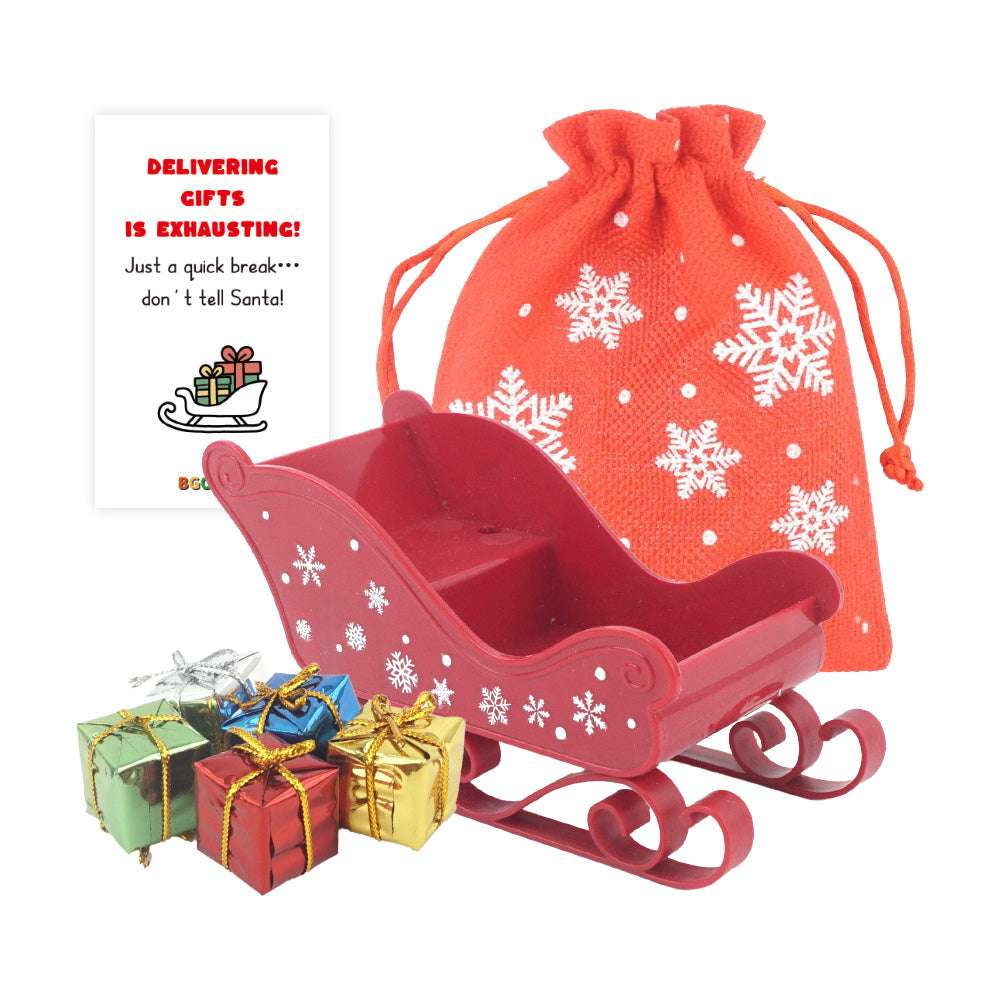 Christmas elf prop set with red sleigh, gift bag, mini gift boxes, snowflake stickers, and activity card for holiday elf scene display