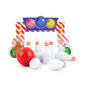 Christmas elf prop set with bowling backdrop, pins, and ball for a holiday elf display.