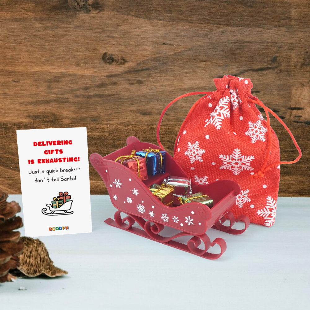 Christmas elf prop set with red sleigh, gift bag, mini gift boxes, snowflake stickers, and activity card for holiday elf scene display