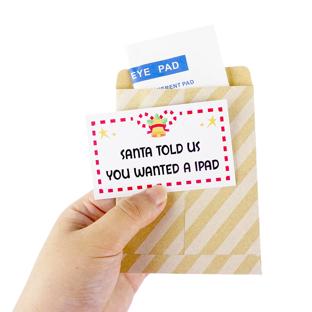 Christmas elf prop set with eye pad packet, paper envelope, and prank card for a holiday elf display.