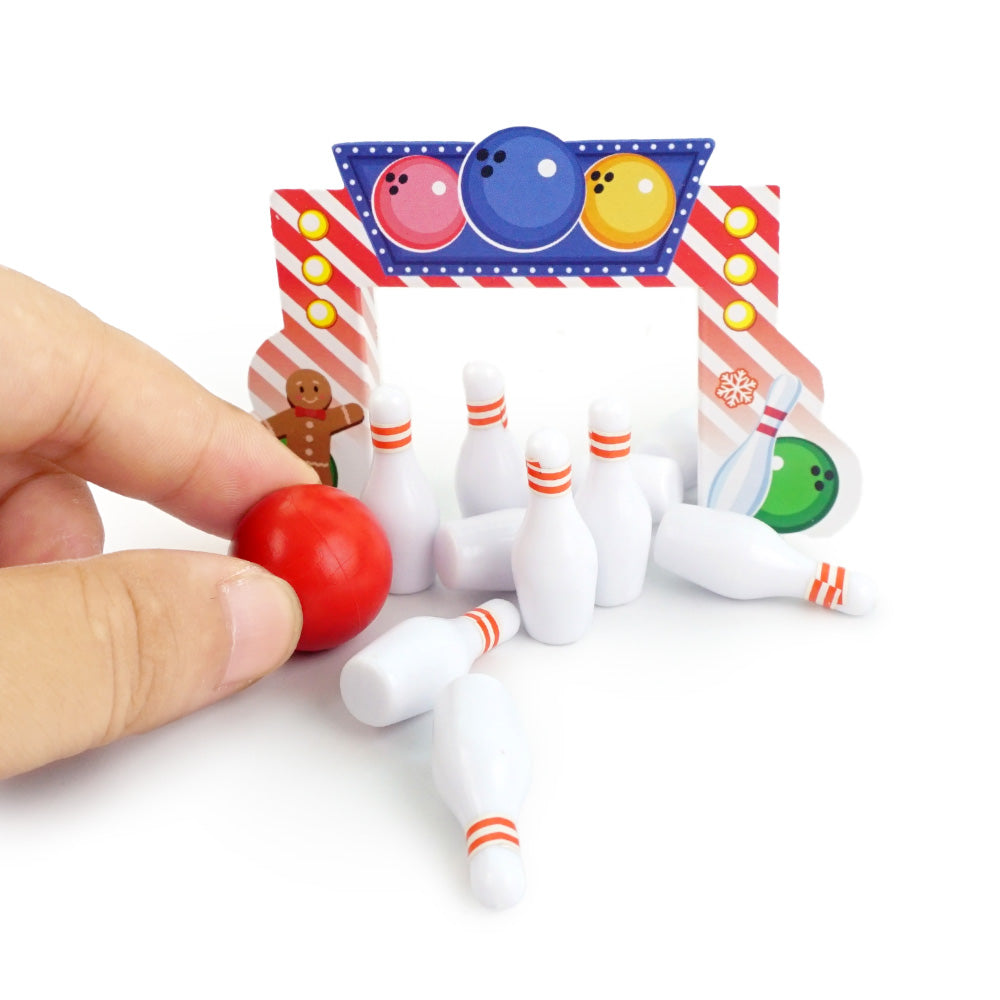 Christmas elf prop set with bowling backdrop, pins, and ball for a holiday elf display.