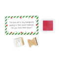Christmas elf prop set with handprint stamps, red ink pad, and activity card for a holiday elf display.

